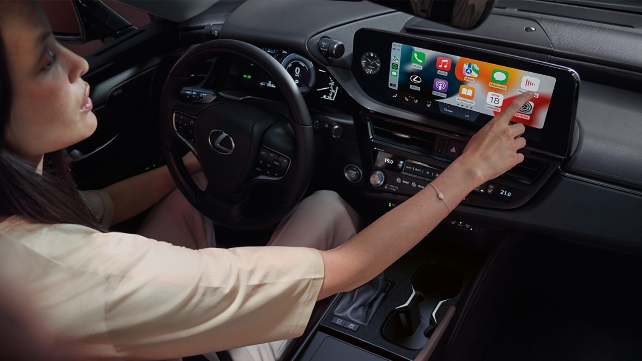 A woman using the multimedia screen within the Lexus ES