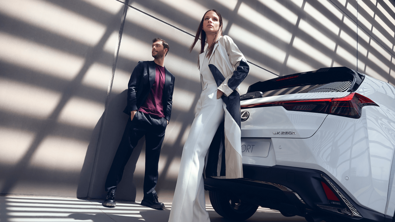 Two people stood behind the Lexus UX
