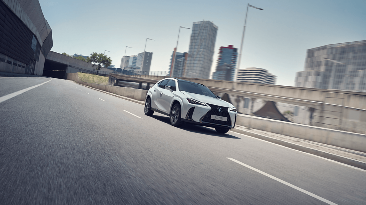  Lexus UX driving down a road