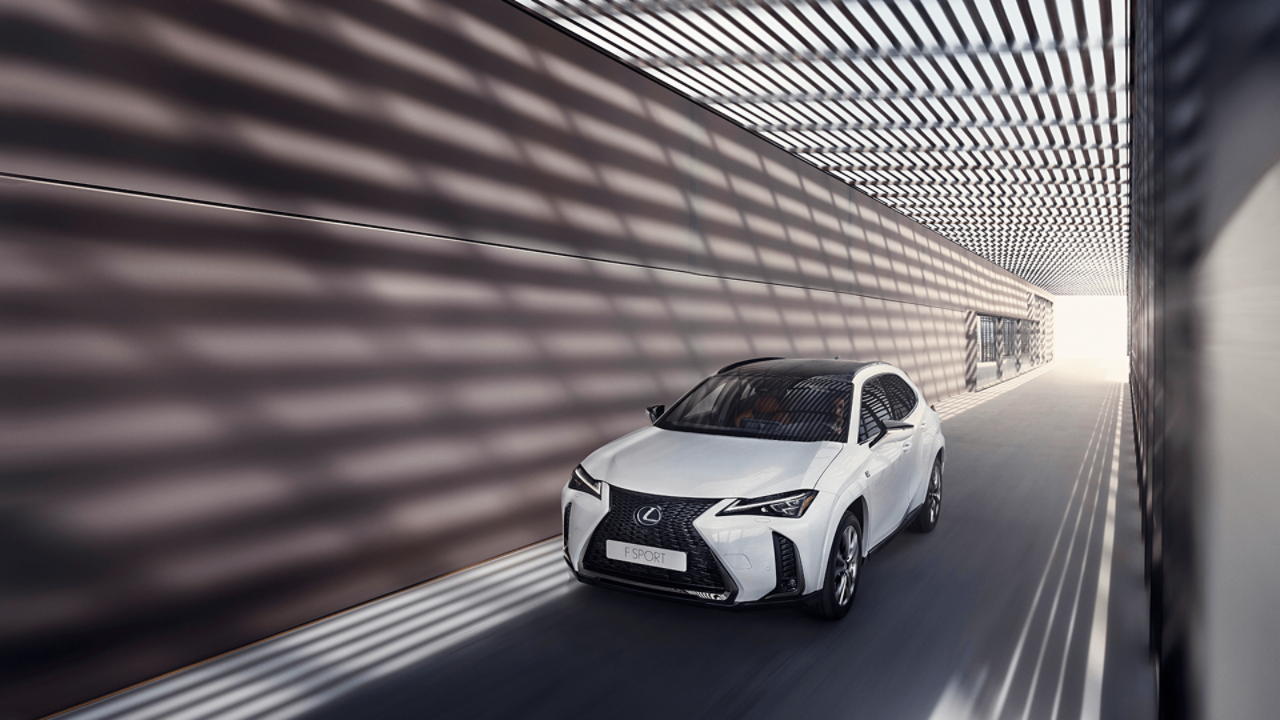  Lexus UX driving down a road